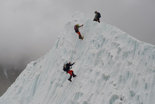 Everest record-holder Kami Rita Sherpa urges limit on climbers as crowds swell on the peak